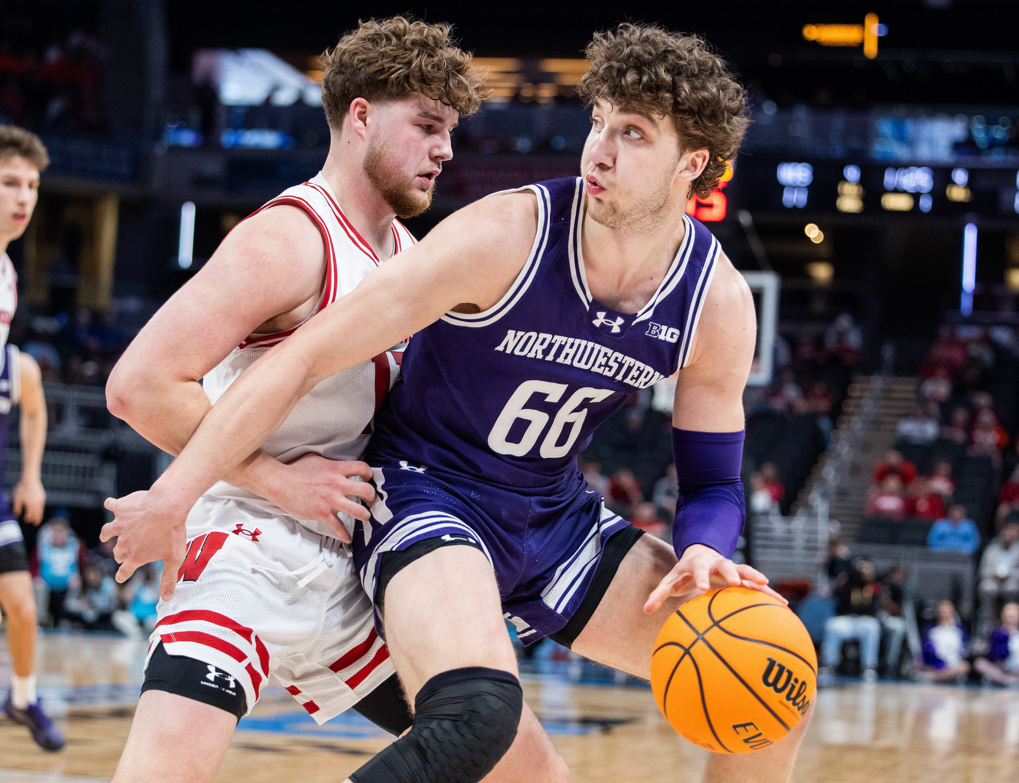 Northwestern Wildcats forward Nick Martinelli (#2) dribbles the ball while Wisconsin Badgers guard Max Klesmit (#11) defends in the first half at Gainbridge Fieldhouse. Photo: Imagn